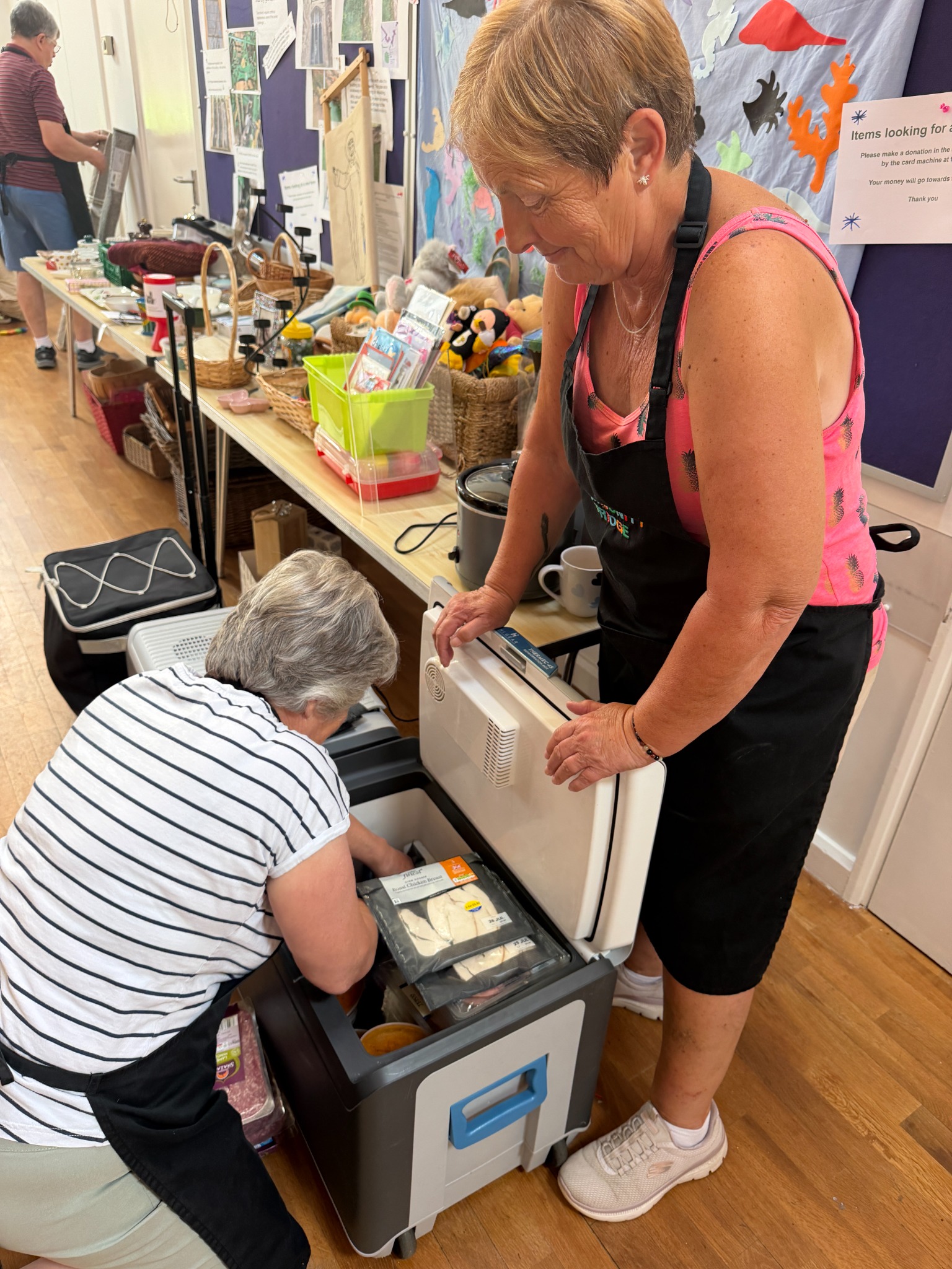 Volunteers handling chilled food at Toddington Community Fridge