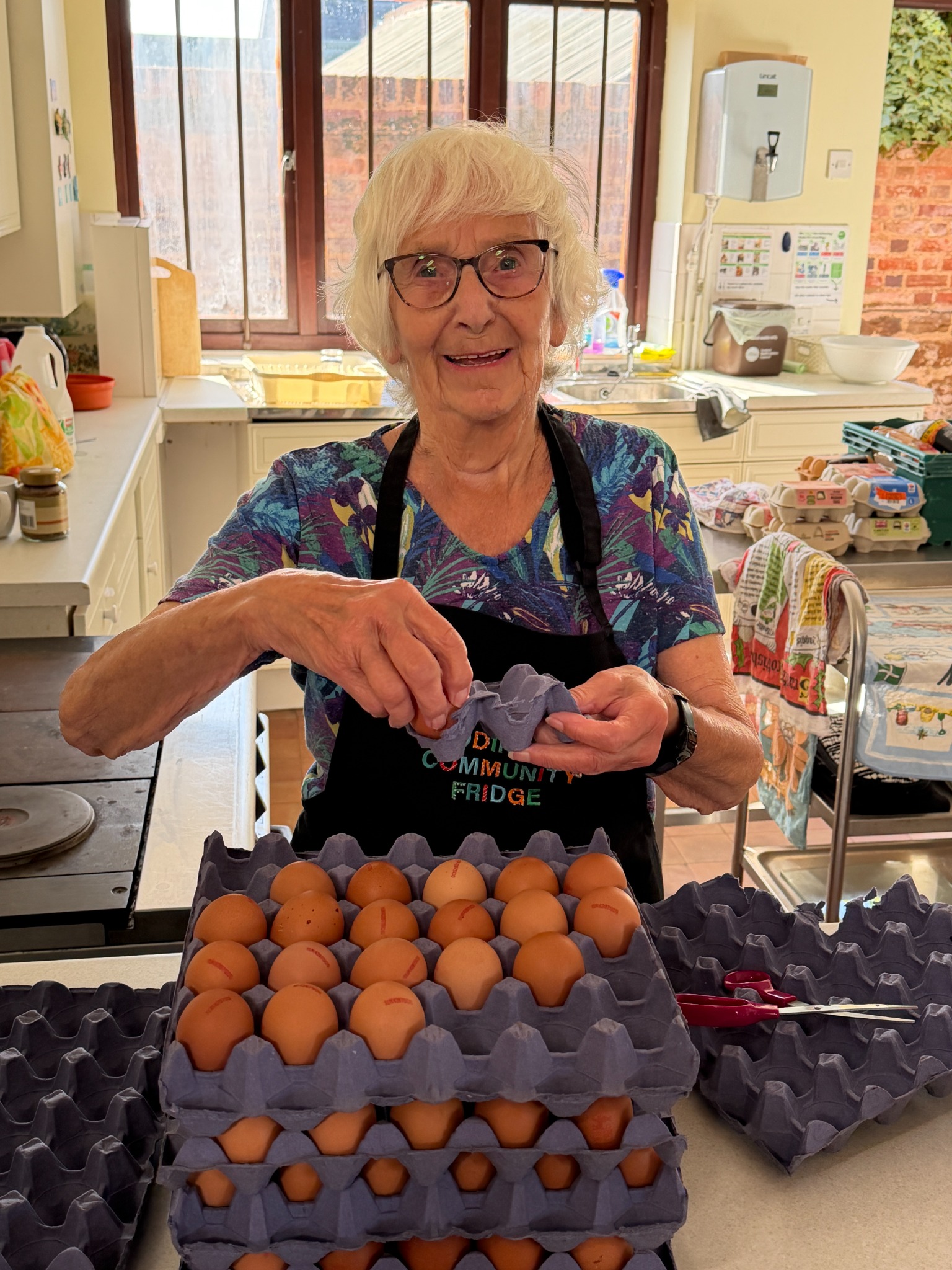 A Toddington Community Fridge volunteer preparing eggs for redistribution